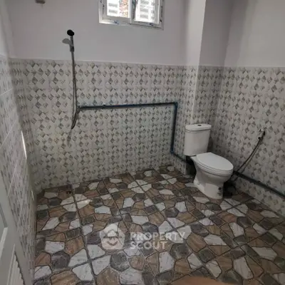 Spacious bathroom with unique tile design and modern fixtures