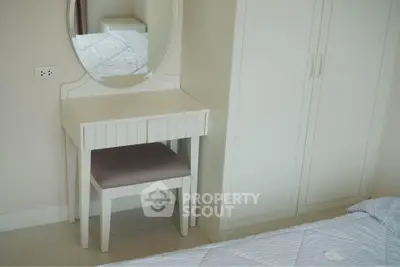 Cozy bedroom with elegant white furniture and mirror