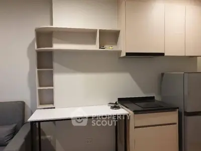 Modern compact kitchen with sleek cabinetry and integrated appliances