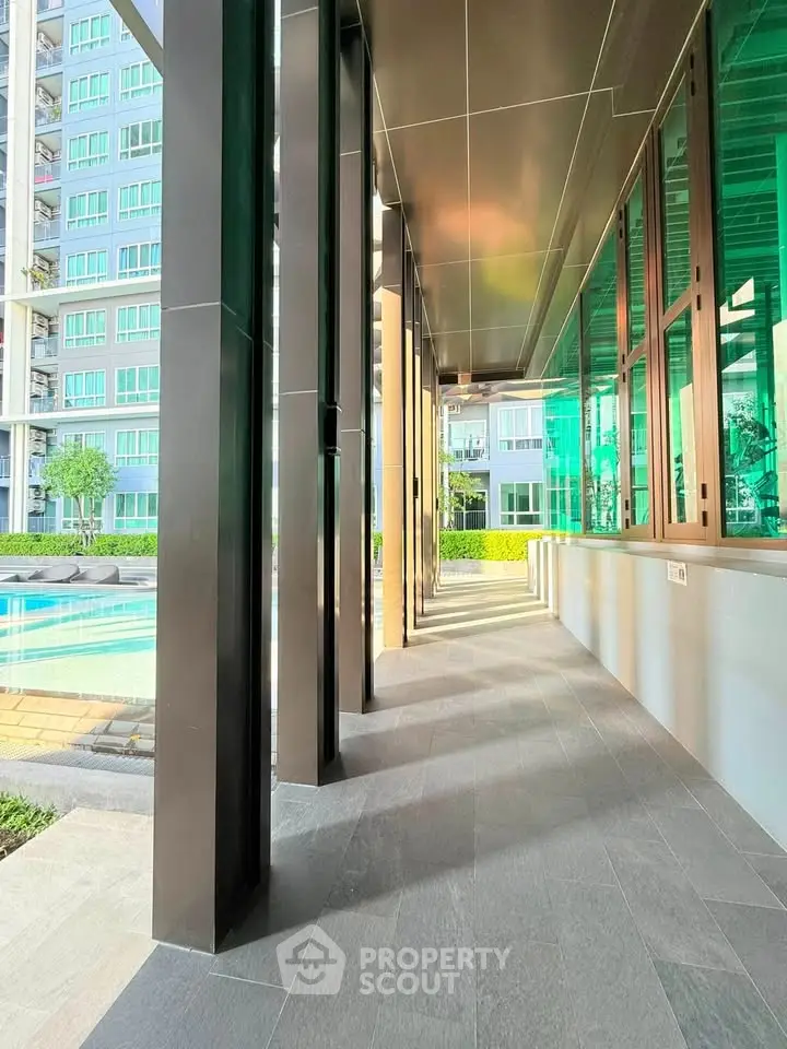 Modern condominium with sleek design and poolside view, perfect for luxury living.