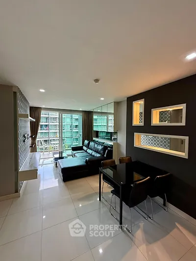 Modern living room with sleek black furniture and large windows offering a stunning city view.