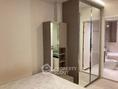 Modern bedroom with mirrored closet and ensuite bathroom