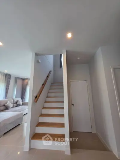 Modern interior with elegant staircase and cozy living area
