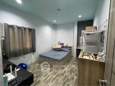 Cozy bedroom with modern decor and ample natural light, perfect for restful nights.