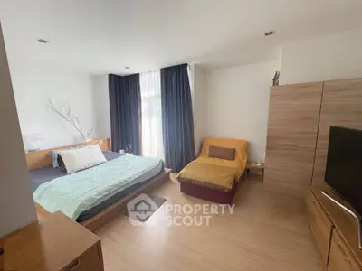 Spacious bedroom with modern furnishings and natural light