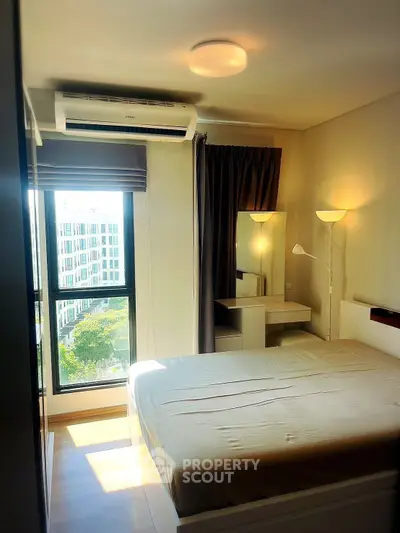 Modern bedroom with large window and natural light in urban apartment