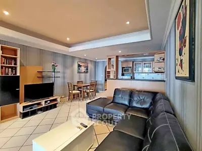 Spacious living room with modern decor and open layout, featuring a cozy sectional sofa and dining area.