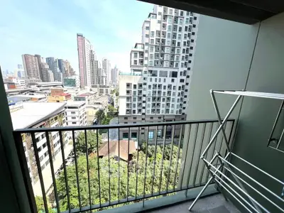 Modern balcony with city view and drying rack in urban apartment