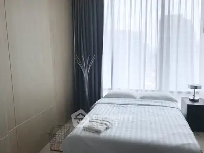 Modern bedroom with large window and city view, featuring minimalist decor and cozy bedding.