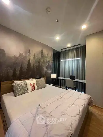 Cozy bedroom with forest-themed accent wall and modern workspace