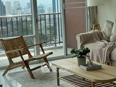 Cozy living room with stylish furniture and floor-to-ceiling windows offering an urban view, perfect for modern city living.
