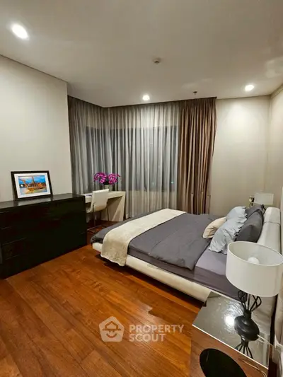 Elegant bedroom with modern decor, featuring a cozy bed, stylish furniture, and warm lighting for a relaxing ambiance.