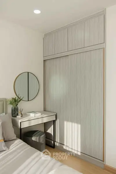 Modern bedroom with sleek wardrobe and stylish vanity in natural light
