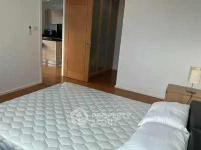 Spacious bedroom with modern design and wooden flooring