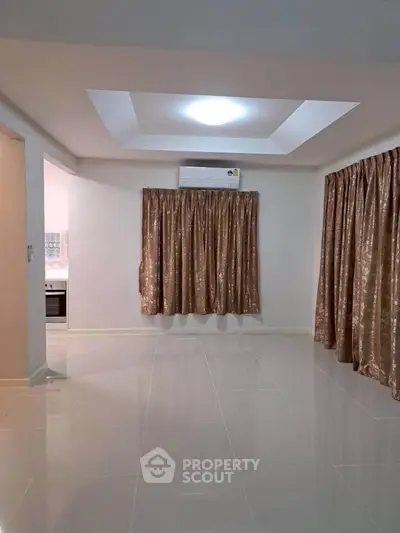 Spacious living room with elegant curtains and modern lighting