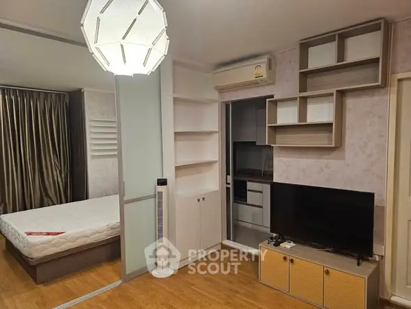 Modern studio apartment with stylish decor and built-in storage solutions.