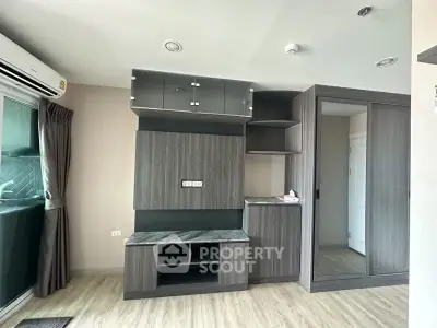 Modern apartment interior with sleek built-in storage and large window for natural light.