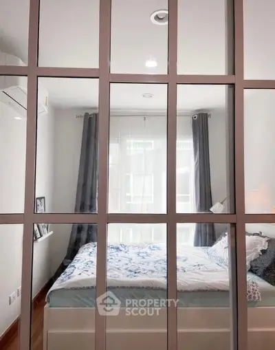 Modern bedroom with large window and stylish decor