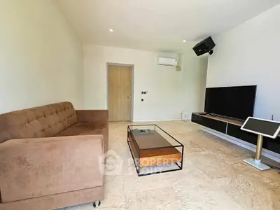 Modern living room with brown sofa, sleek TV setup, and minimalist decor.