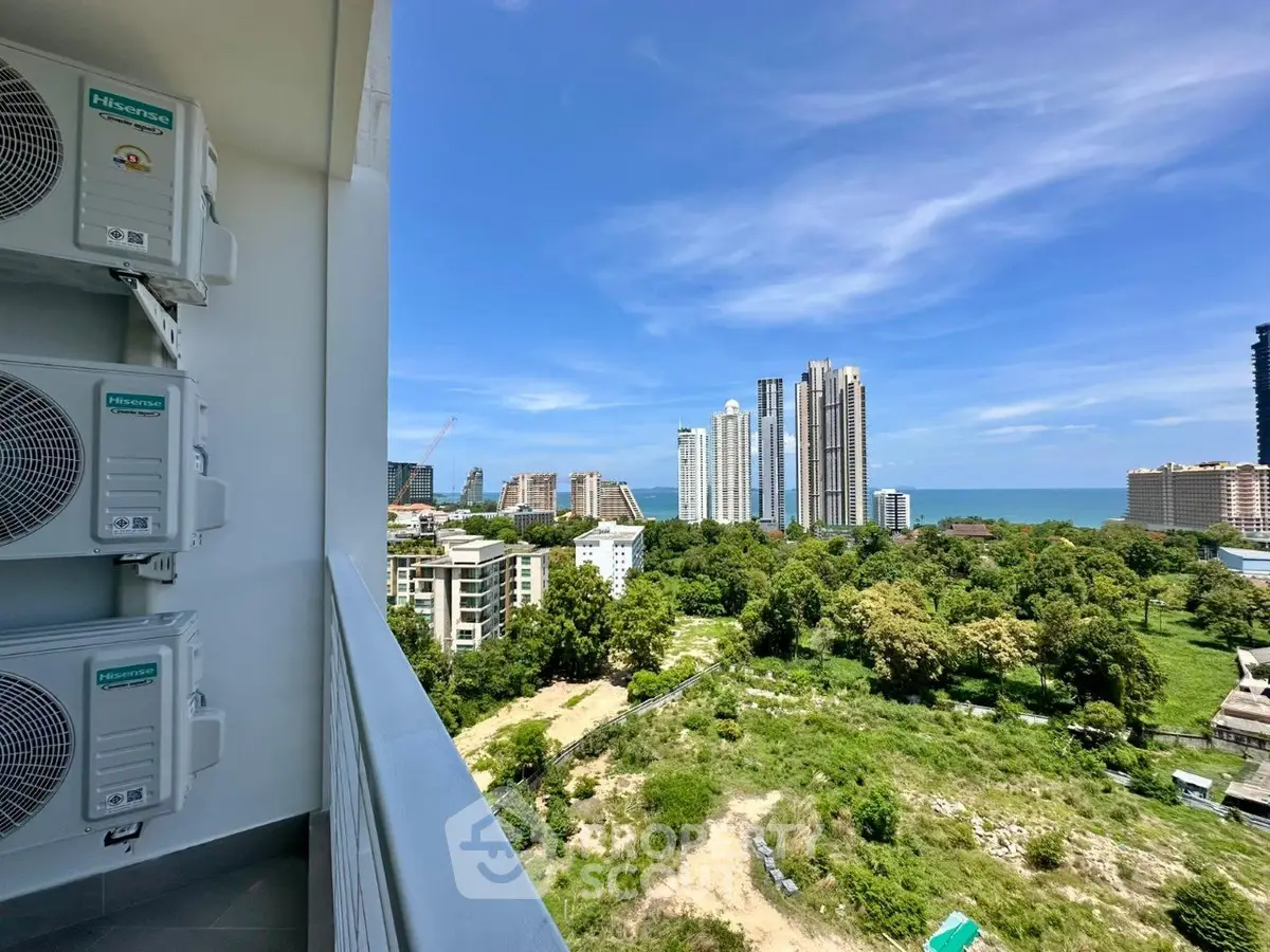 Stunning high-rise view from balcony overlooking cityscape and ocean, perfect for urban living.