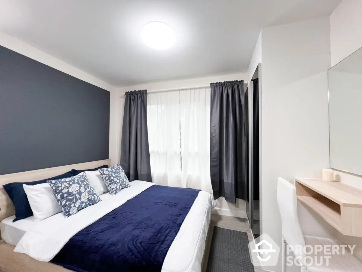 Modern bedroom with stylish decor and natural light, featuring a cozy bed and elegant curtains.