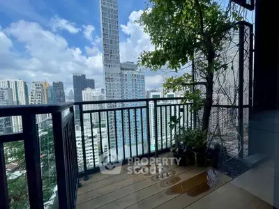 Stunning city view from a modern balcony with lush greenery and sleek railing.