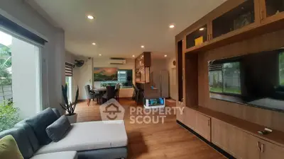 Spacious modern living room with open kitchen and large windows