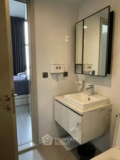 Modern bathroom with sleek vanity and mirror in stylish apartment