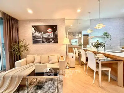 Modern living room with open kitchen, stylish decor, and cozy ambiance in a contemporary apartment.
