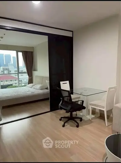Modern apartment with glass partition, cozy bedroom, and city view