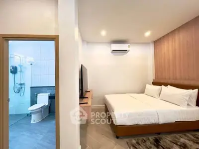 Modern bedroom with ensuite bathroom, featuring a cozy bed and sleek design, perfect for comfort and relaxation.