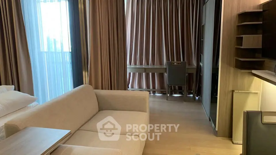 Modern living room with beige sofa and elegant curtains in a stylish apartment.