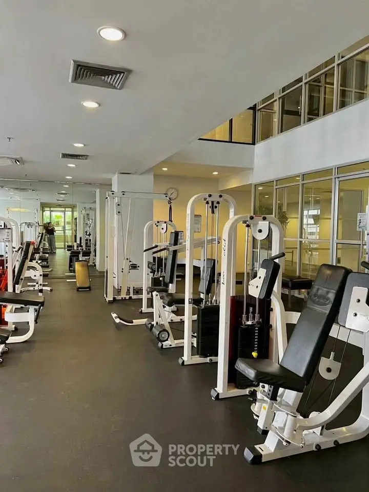Spacious modern gym with state-of-the-art fitness equipment in a residential building.