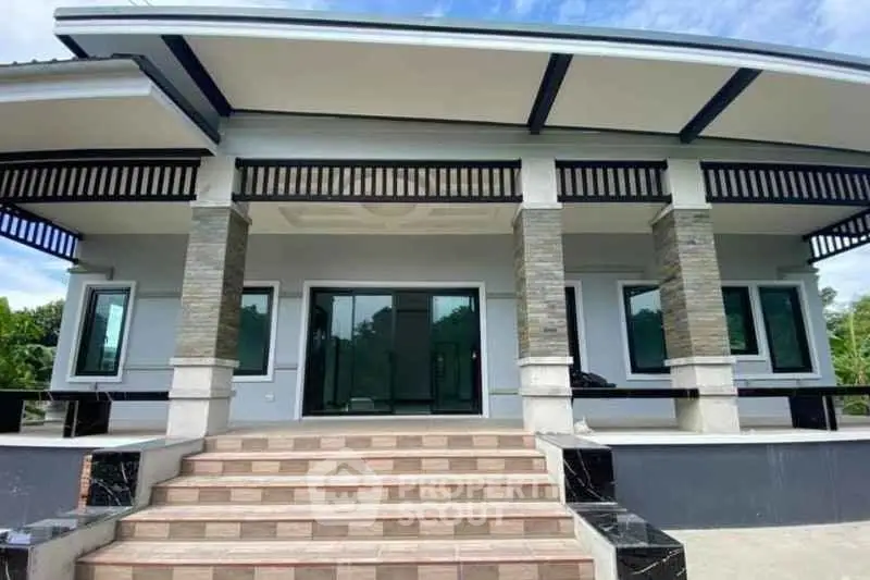 Modern single-story home with stylish facade and spacious front steps.