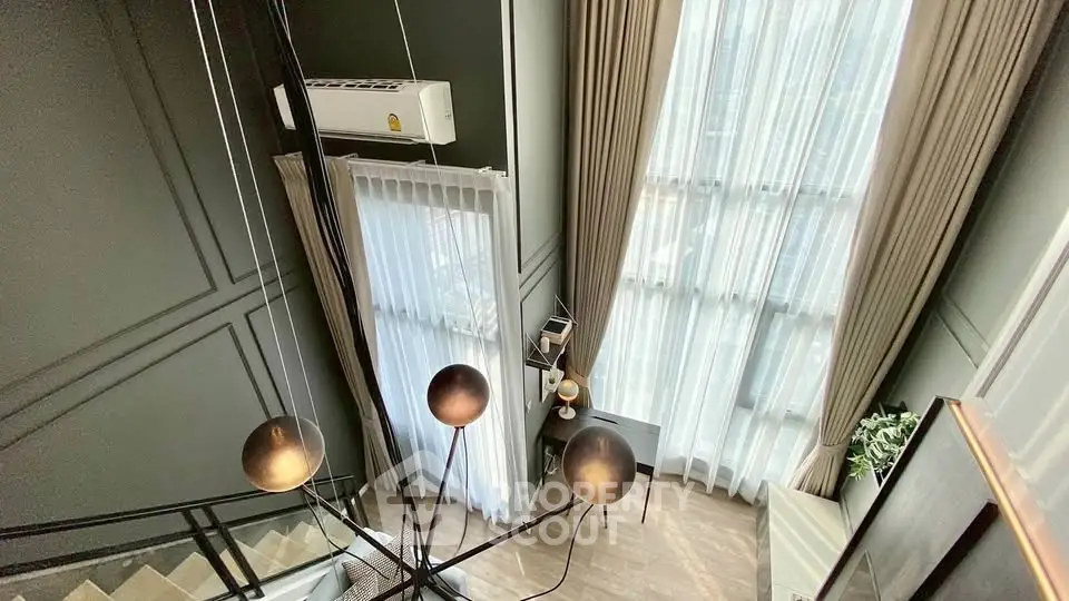 Modern duplex interior with high ceilings and elegant lighting