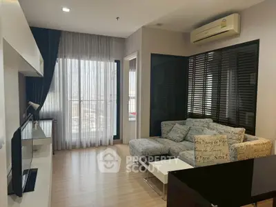 Modern living room with stylish sofa and large window offering city view