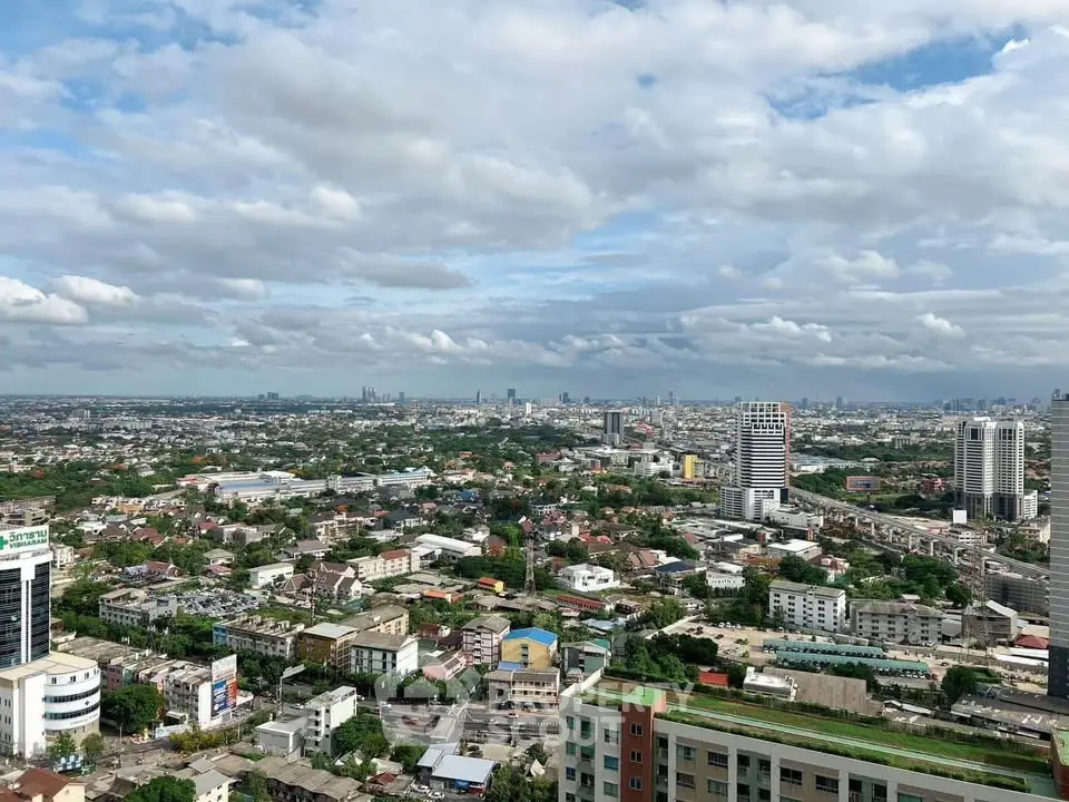 Stunning cityscape view showcasing urban skyline and residential areas under a vibrant sky.