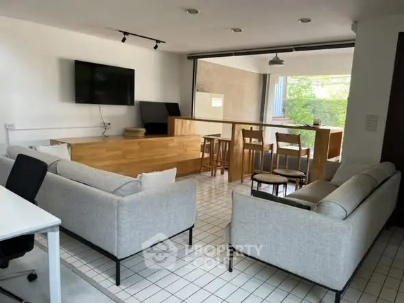 Modern open-plan living room with stylish furniture and natural light