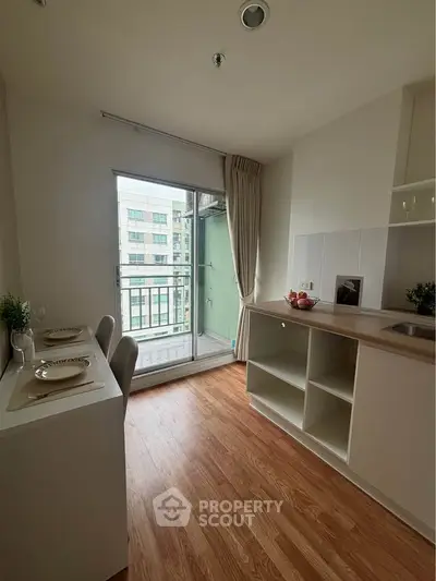 Modern kitchen with open layout and balcony view in urban apartment