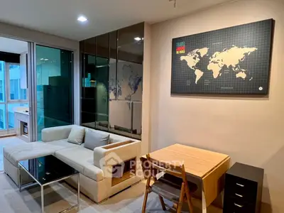 Modern living room with stylish furniture and world map decor, featuring a cozy sofa and dining area.