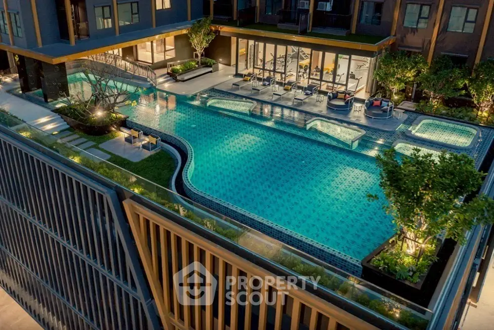 Luxurious rooftop pool with modern design and ambient lighting in upscale apartment complex.