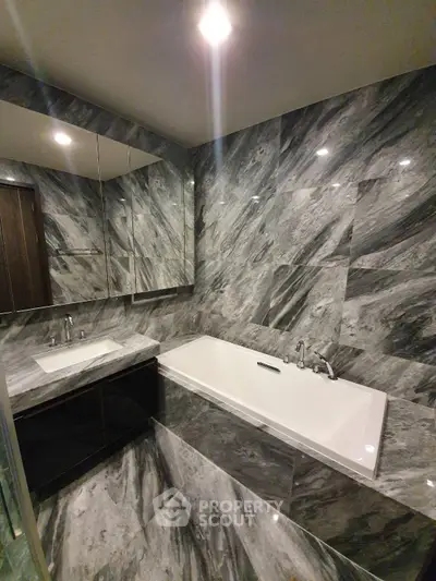 Luxurious marble bathroom with elegant bathtub and mirrored cabinets