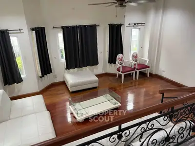Spacious living room with elegant wooden flooring and modern furniture