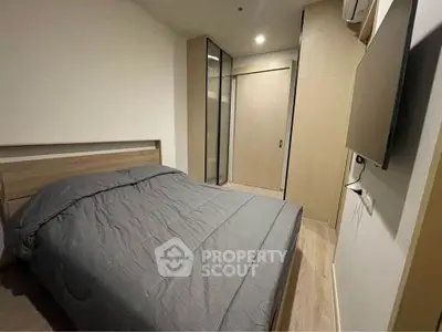 Modern bedroom with sleek design and built-in wardrobe, perfect for urban living.