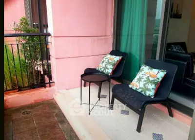 Charming balcony with cozy seating and vibrant cushions, perfect for relaxation and enjoying outdoor views.