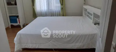 Spacious bedroom with large bed and natural light from window