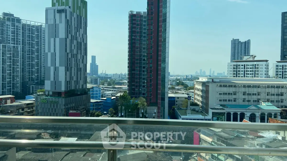 Stunning cityscape view from a high-rise balcony overlooking modern skyscrapers and urban skyline.