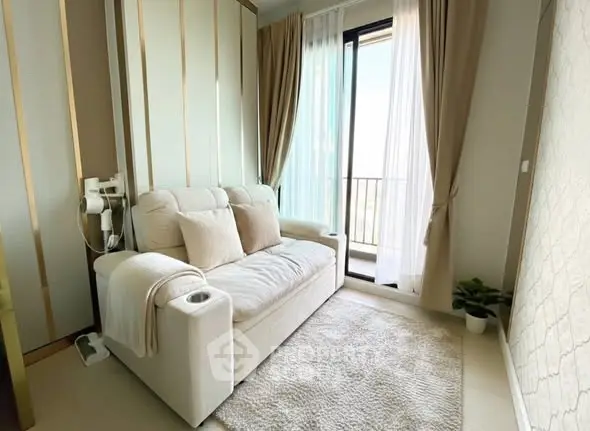 Cozy living room with plush sofa and balcony view, perfect for relaxation.