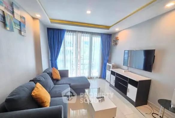 Modern living room with blue curtains and cozy sofa in bright apartment