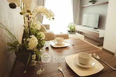 Elegant living room with modern decor and natural light, featuring a cozy dining area and stylish furniture.